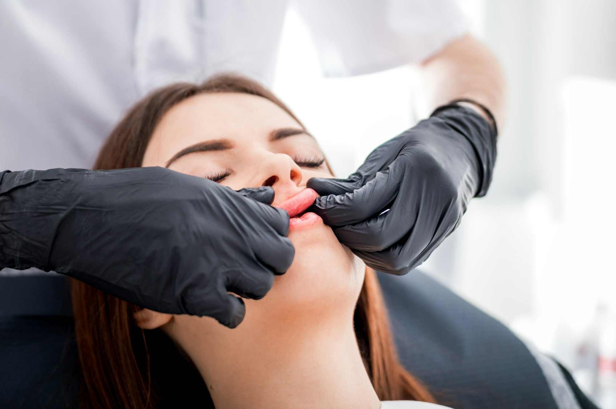 Massage after enlarging lips at beauty salon